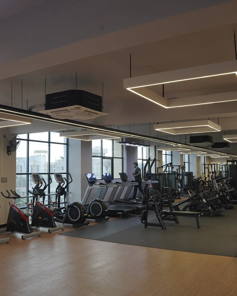 Spacious Cardio Zone Overview with Treadmills and Spin Bikes